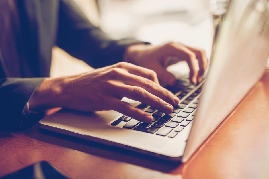 person typing on a laptop