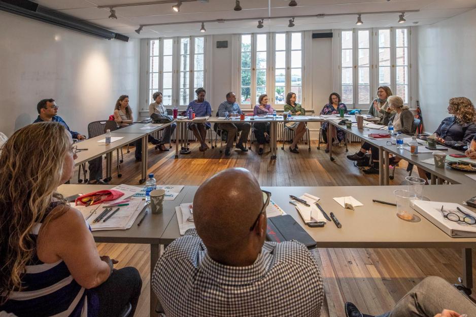 twenty professors sit in a square talking about writing