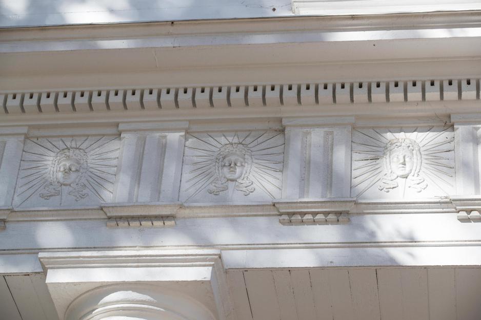 Apollo heads on the entablature on Pavilion one