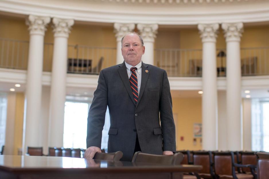 Philip Bourne standing at a table in the Rotunda looking at the camera