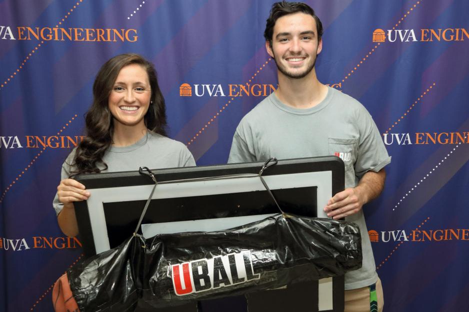 Molly and Tim Shields hold Uball for a picture