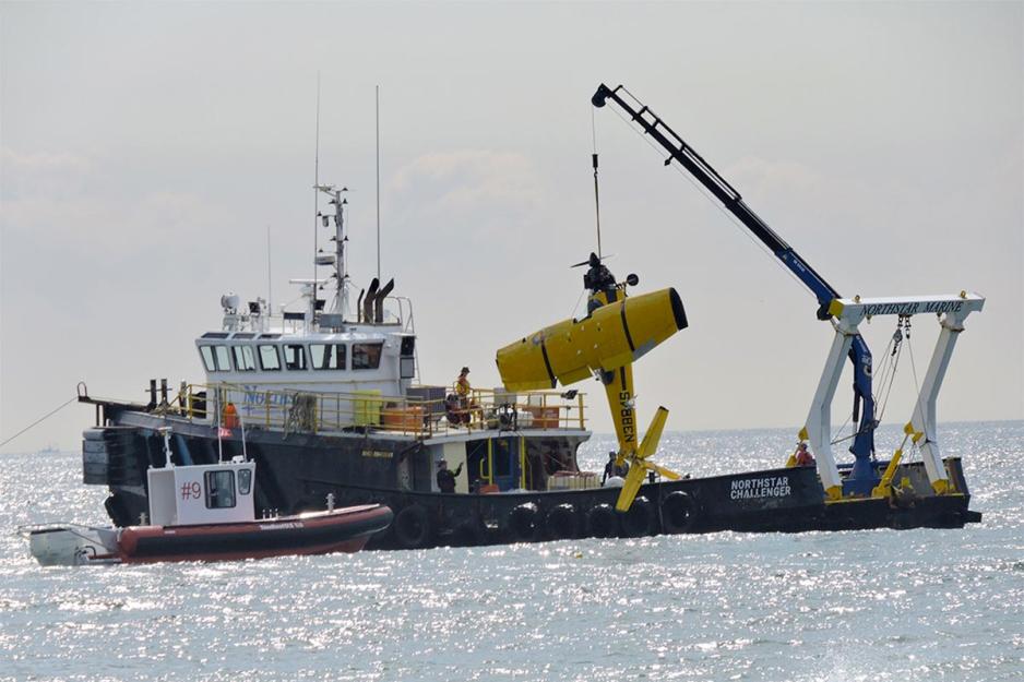 The boat Northstar Challenger helps to pull out an airplane that crashed in the ocean