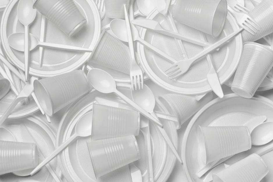 Stack of plastic utensils, plates, and cups