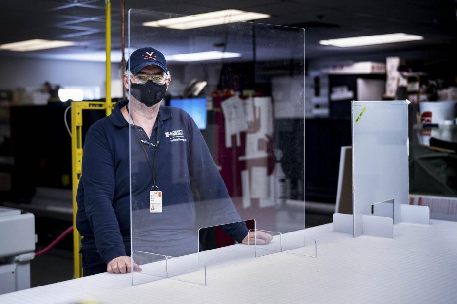 Warren “Hubba” Wood stands with a plexiglass barrier that has been fully put together