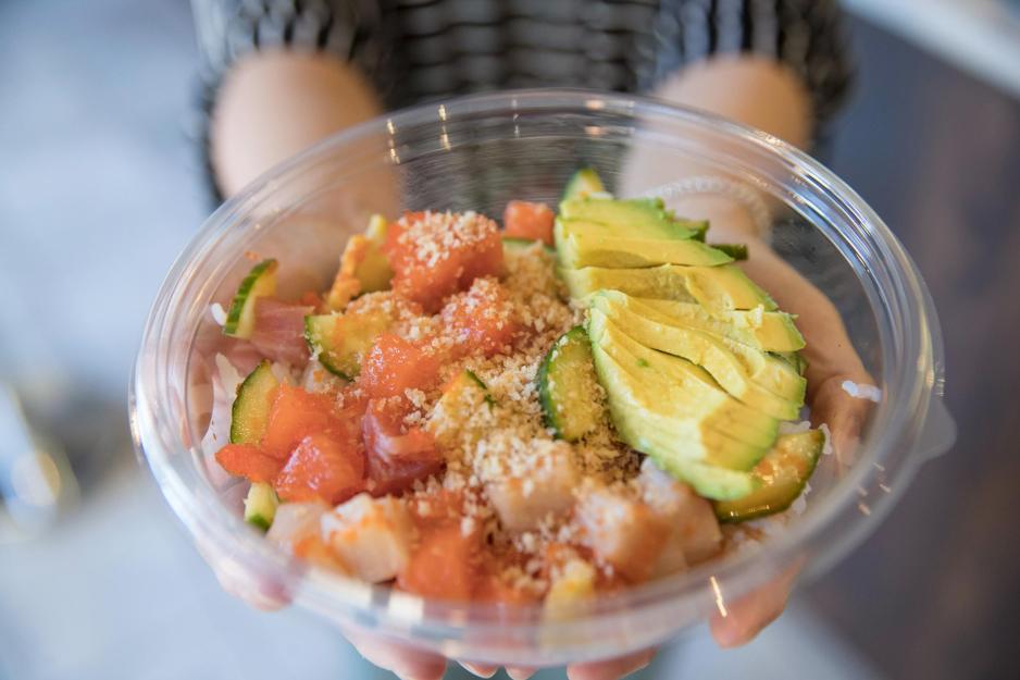 person holding a Poke Sushi Bowl