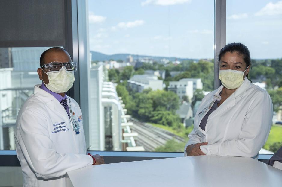 Dr. Alexandra Kadl and Dr. Chintan Ramani stand at a table together