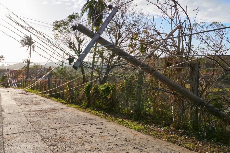 Powerlines touching the ground and poles leaning over due to a Hurricane