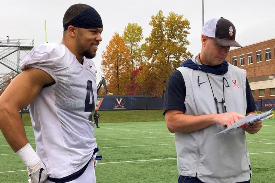  Bronco Mendenhall, right, and Jordan Mack, left,  stand together on the football field
