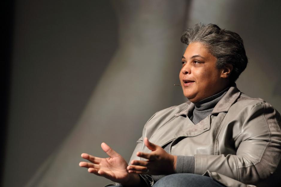 Roxane Gay speaking to a crowd while sitting