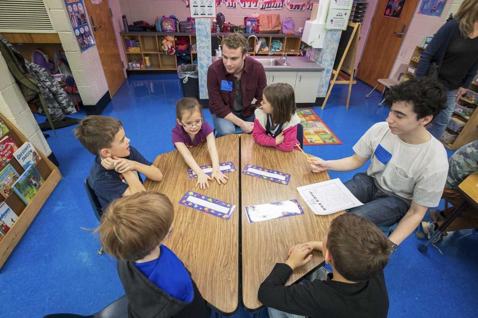 Bryan Christ, top, visit a group of school children