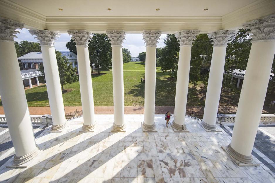 Arial view from inside of the Rotunda looking down at a student walking up the steps of the Rotunda