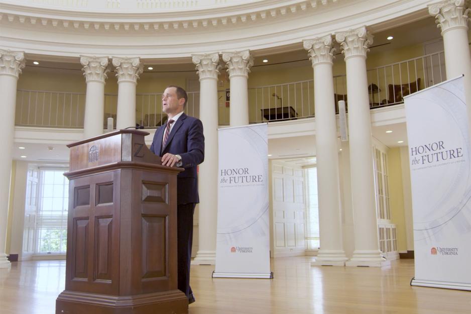 President Jim Ryan standing at a wooden podium in the Rotunda