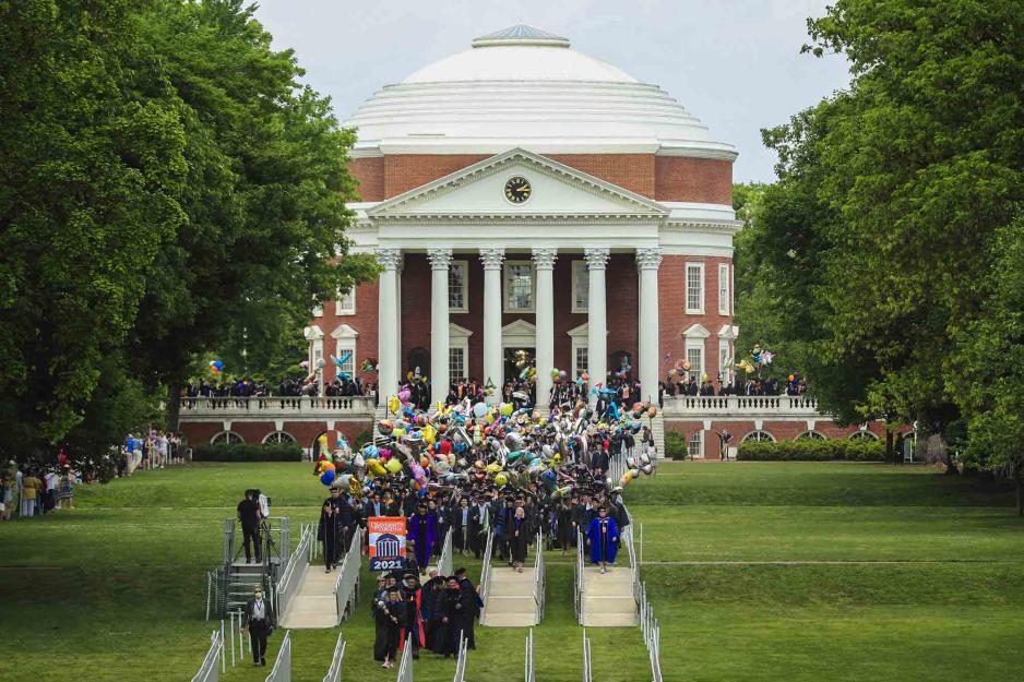 Graduates walking across the lawn from the Rotunda