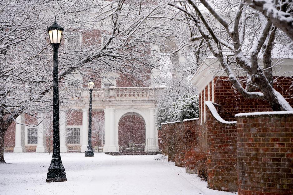 Snow falling on Grounds while the brick wall start to get covered