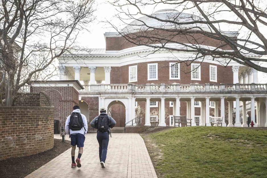 Students walking a sidewalk towards the Rotunda