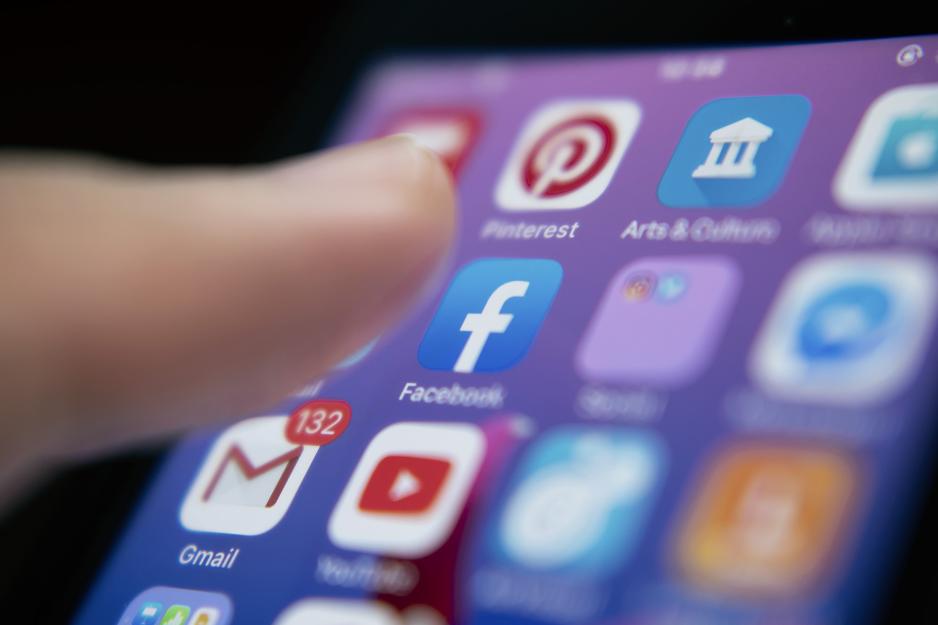 up close view of someone getting ready to click on an app on their phone