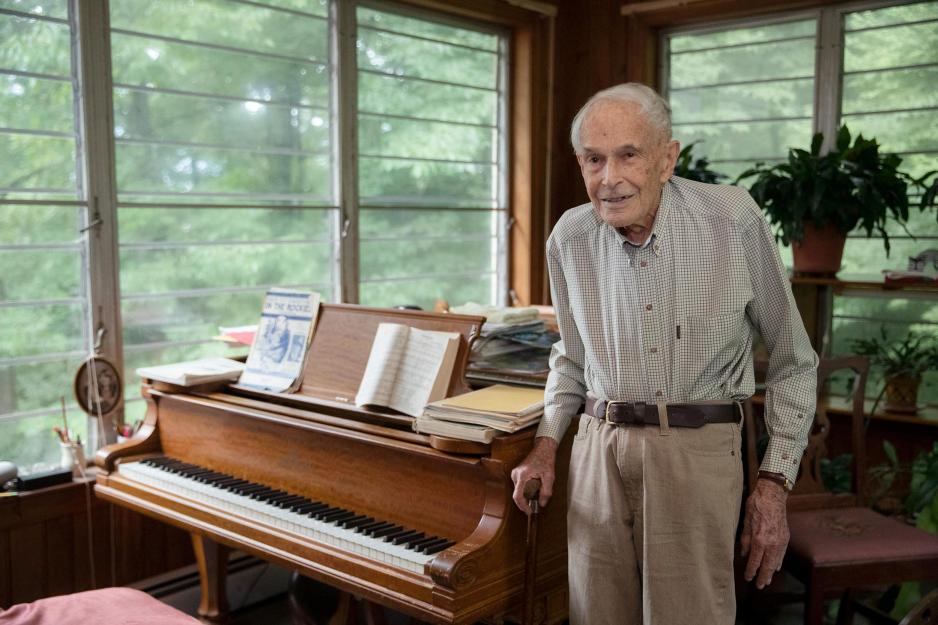 Thomas Crowell stands next to a piano