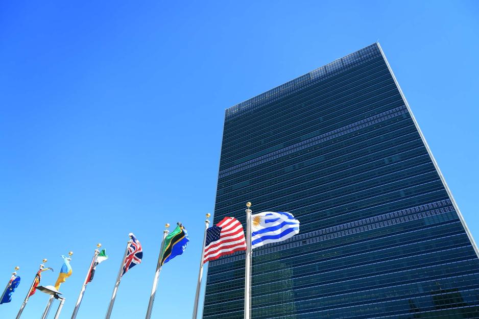 Skyskraper surrounded by various countries flags