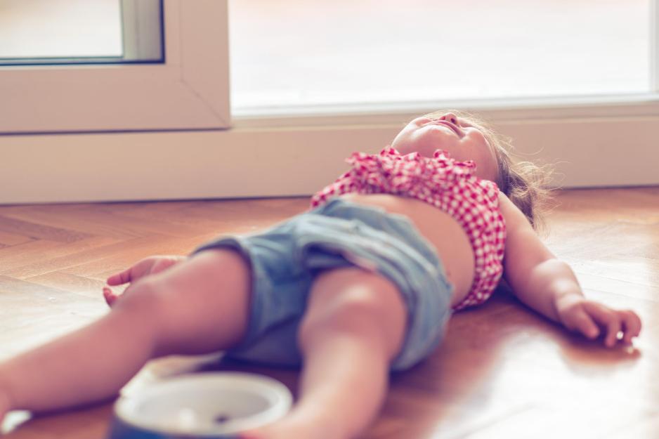 Child laying on the floor having a temper tantrum 