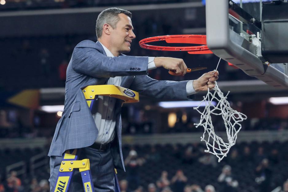 Tony Bennett cuts down the net while standing on a ladder