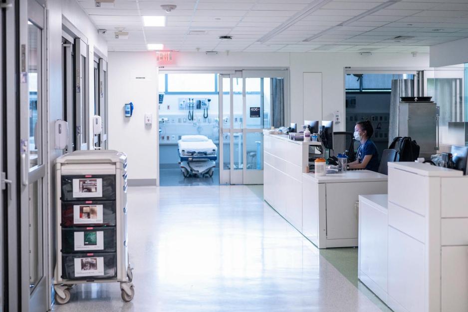 Nurse sitting at a nurses station working on a computer