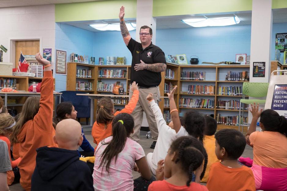 Tyler Dean leads students in a warm-up 