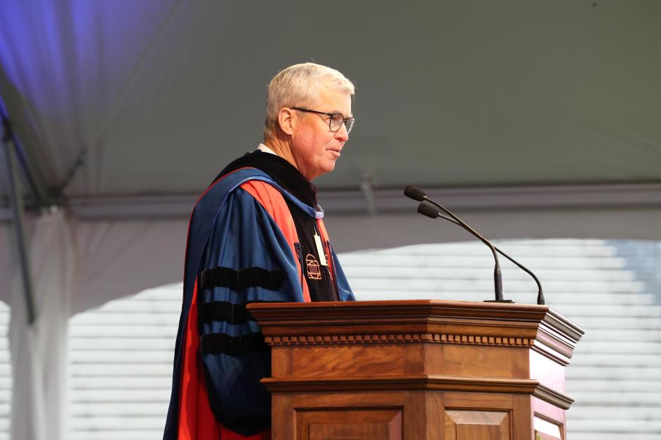 James B. Murray Jr. standing at a wooden podium giving a speech at Final Exercises