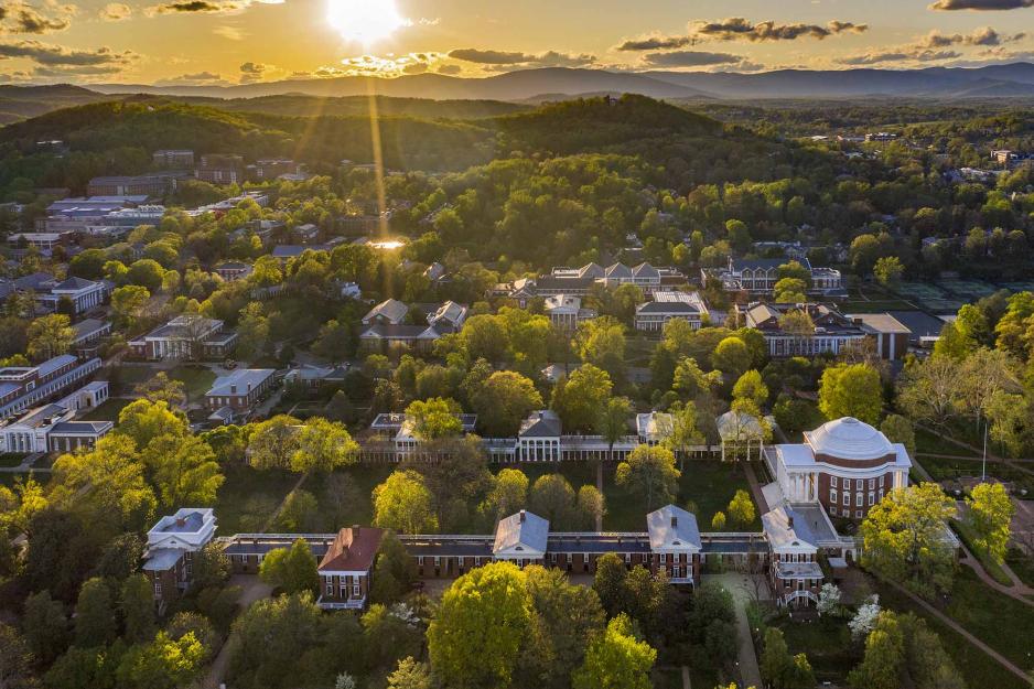 Arial view of the Rotunda as the sun starts to set behind the Blue Ridge Mountains