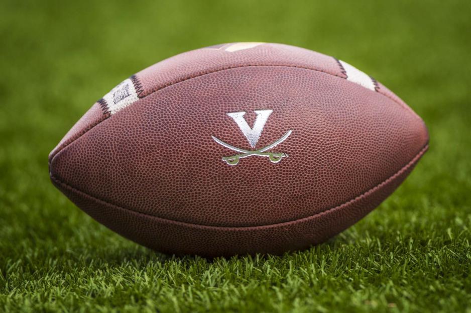 Football with UVA logo on grass