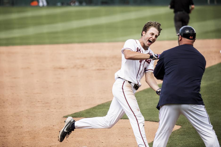 A jubilant Kyle Teel rounds third base while giving his couch a highfive