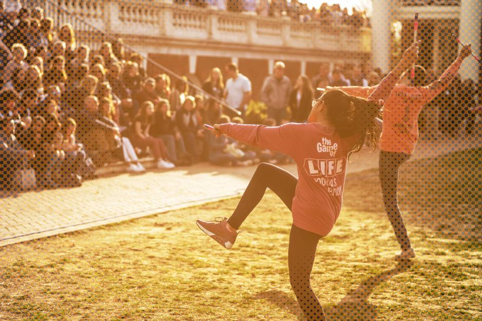 Students gather on the Rotunda to watch a performance on the lawn