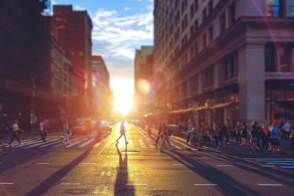 people walking across a busy crosswalk