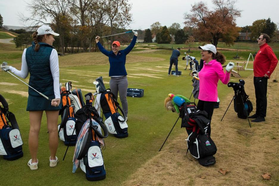 Sherri Moore and Paul Seaborn, right, stand talking while stretching before playing golf