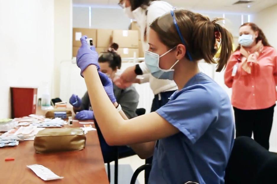 UVA healthcare workers drawing up vaccines