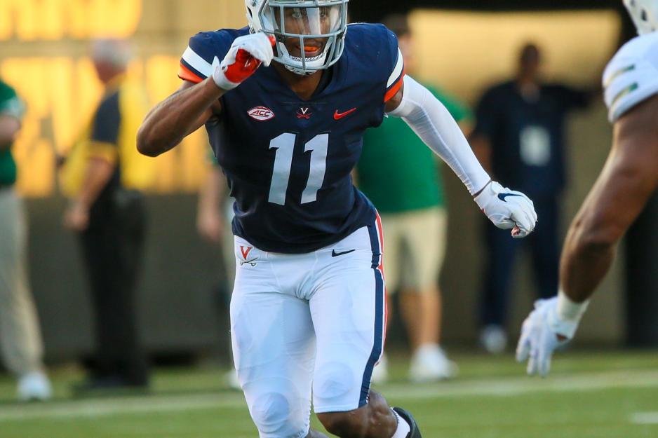 Charles Snowden running down the football field against a defender
