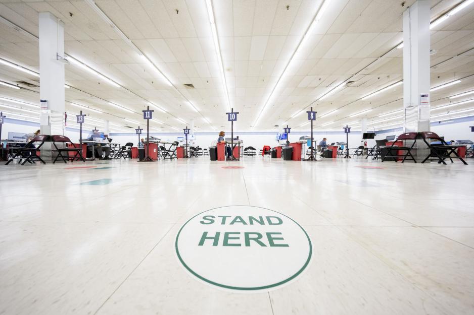 UVA Vaccination clinic with a floor sticker that says stand here