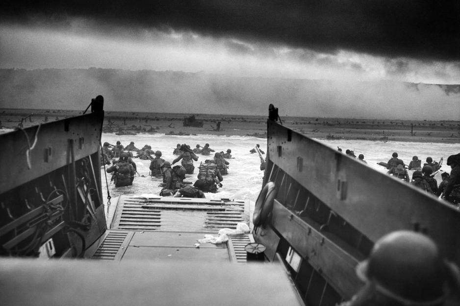 Black and White image of Troops leaving their boats at Normandy