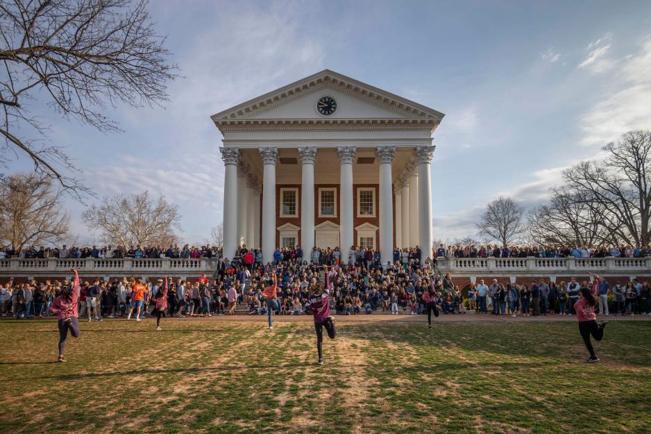 Rotunda filled with people on its sidewalks watching students perform