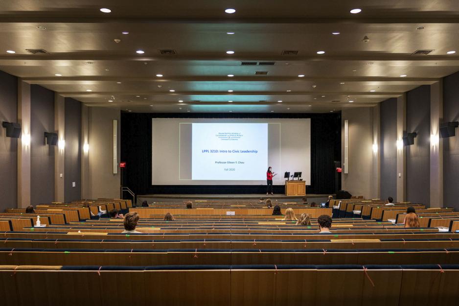 Professor teaching at the front of the class while the students are socially distanced