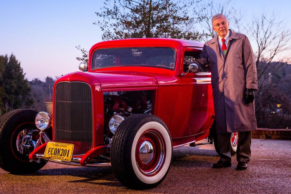 Elzinga stands next to an old red car
