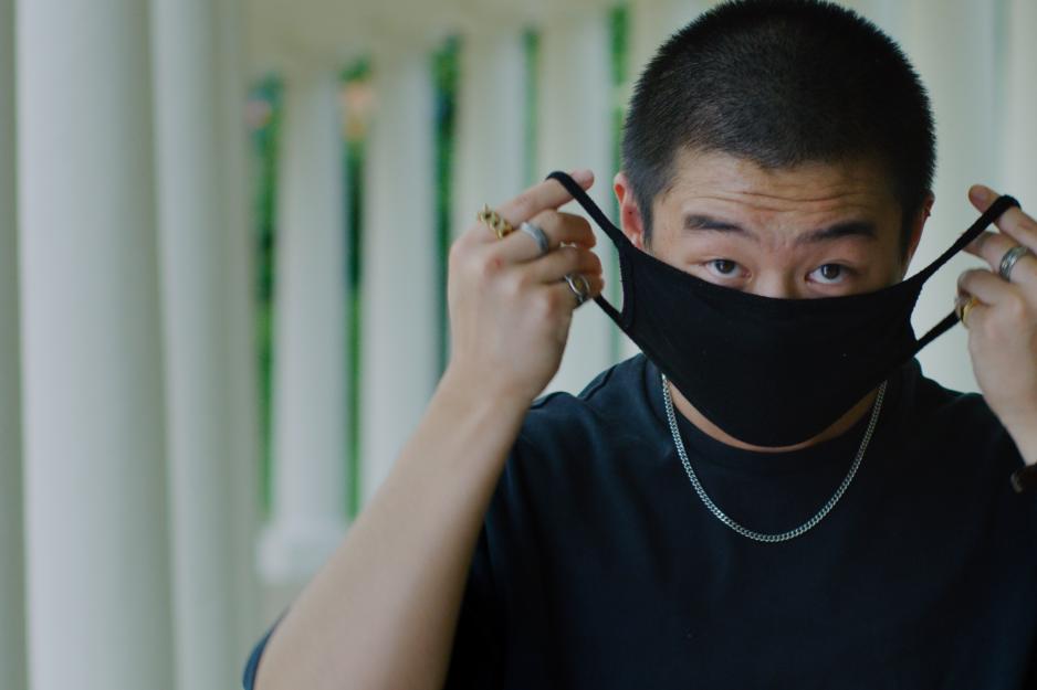 Student placing a mask on their face