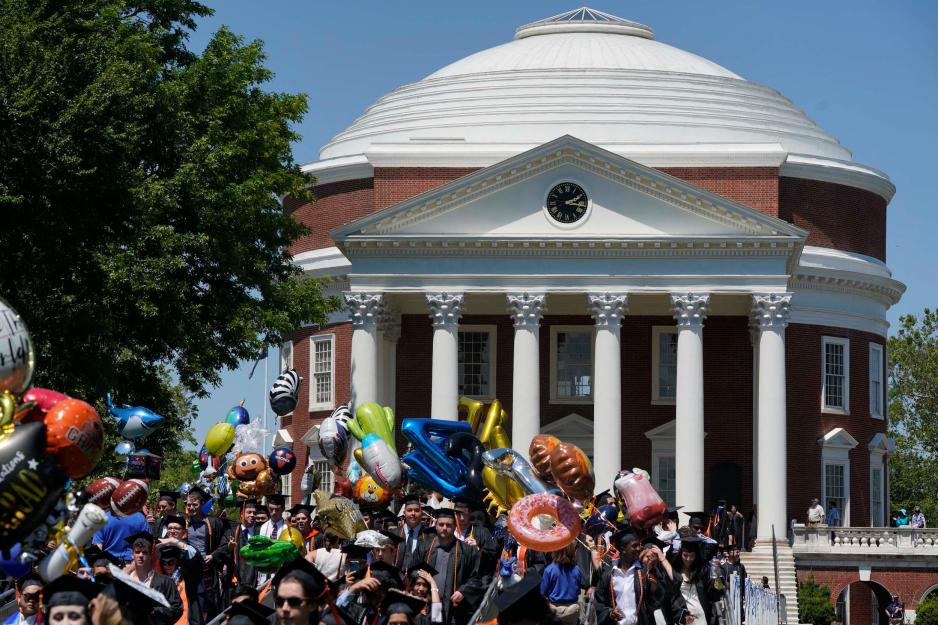 Graduates walking across the lawn from the Rotunda