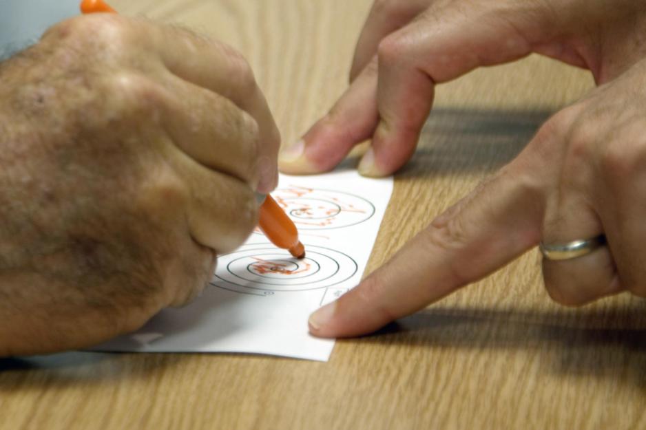 Man attempting to trace a spiral as a test before a procedure