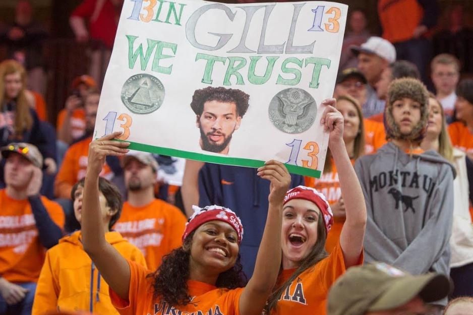  UVA fans holding a sign that reads In Gill we trust