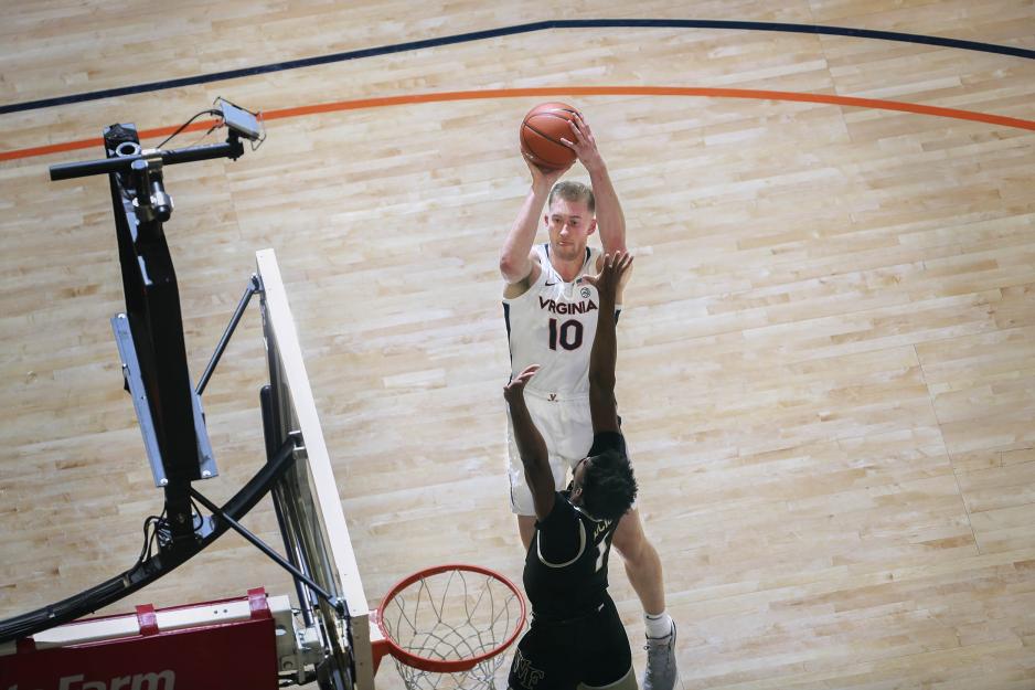 Sam Hauser shooting over an opponent  during an basketball game