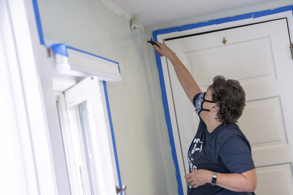 UVA team member painting wall