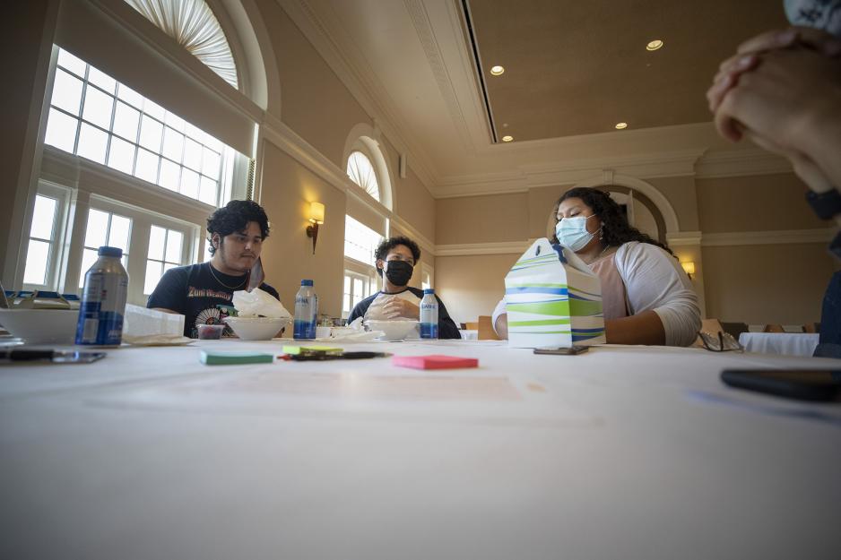 Group of students sitting at a circle table talking