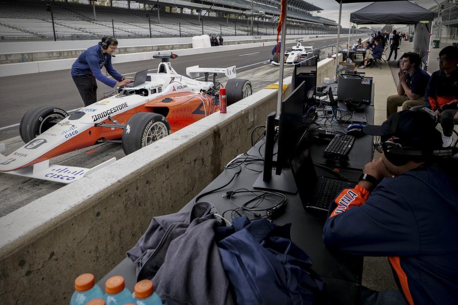 Amar Kulkarni, left, preparing the UVA autonomous race car in the Cisco challenge