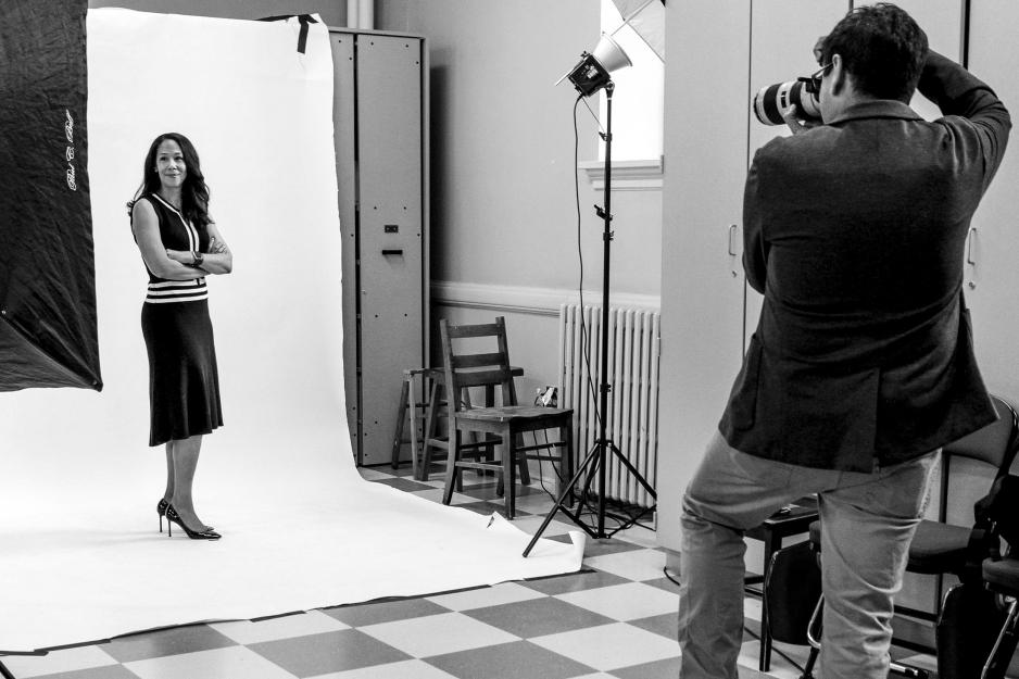 Sanjay Suchak taking a picture of a woman against a white and black background
