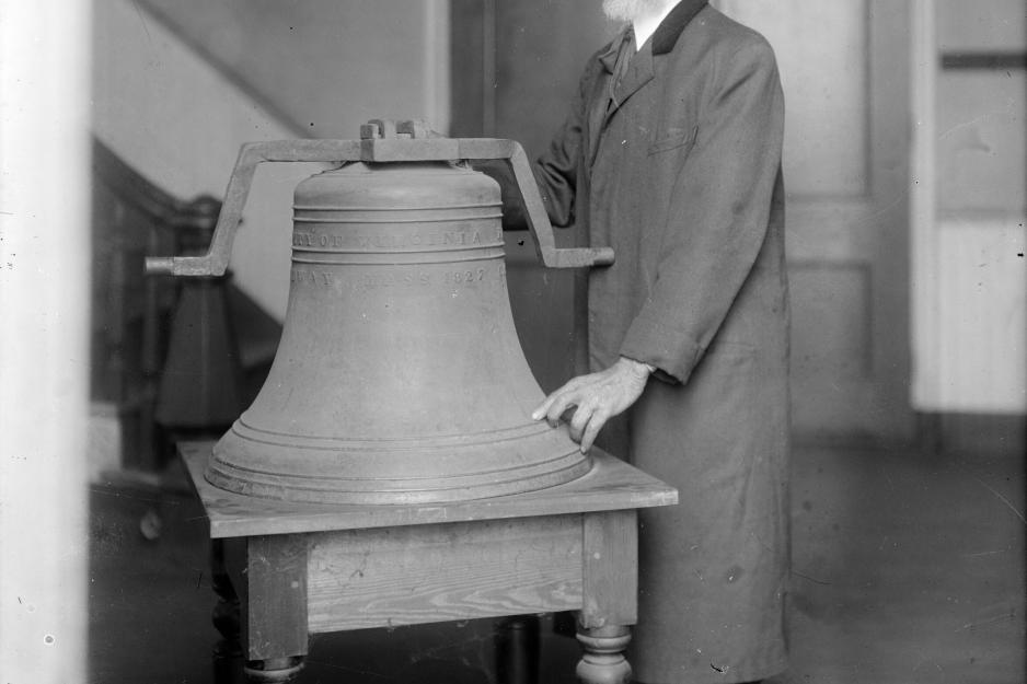 Henry Martin standing next to a bell